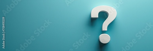 White question mark on teal background, minimalist copy space, symbolizing inquiry and curiosity photo