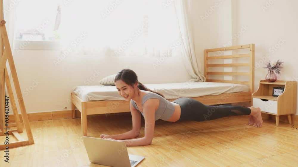 Beautiful happy girl with closed eyes practicing yoga in lotus position in bedroom in the mornin Beautiful happy girl with closed eyes practicing yoga in lotus position in bedroom in the mornin