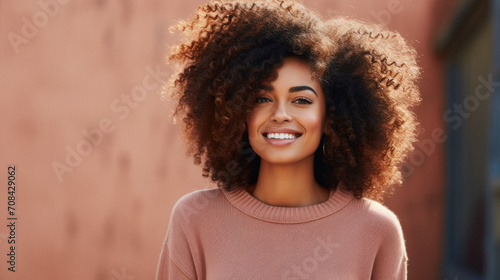 Portrait of a beautiful young african american woman smiling outdoors © Synthetica