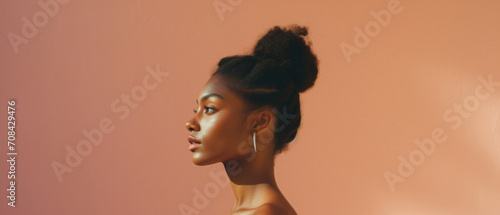 Beautiful african american woman looking away on pink background photo