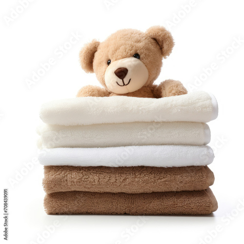 Teddy Bear Sitting on Stack of Folded Towels