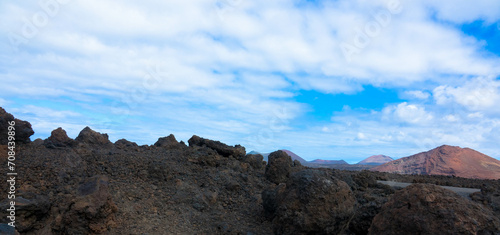 Spectacular view of the Fire Mountains at Timanfaya National Park, this unique area consisting entirely of volcanic soils. Volcanic landscape in a sea of ​​lava. Plenty space of text. Lanzarote, Spain