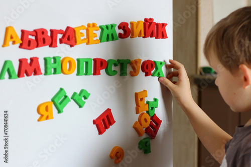 the child is playing with the letters of alphabet. Intellectual play, preschool primary education