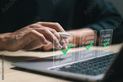 Businessman use laptop with making correct sign mark on online document to approve corporate project. Business project approval concept.