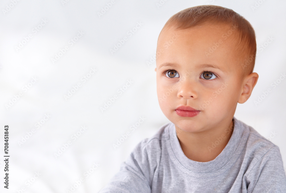 Thinking, cute and boy baby on bed in the nursery of modern home relaxing and sitting. Calm, mockup and serious young kid, infant or toddler with child development for growth in bedroom at house. Thinking, cute and boy baby on bed in the nursery of modern home relaxing and sitting. Calm, mockup and serious young kid, infant or toddler with child development for growth in bedroom at house.