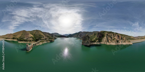 360 view. VR pano. Reservoir between mountains. Panoramic aerial view over the water of dam and dammed water between mountains. Water reservoir with colorful water color. Andalusia. Spain. photo