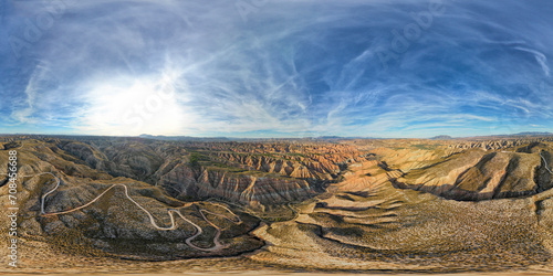 VR 360 view. Gorafe Desert. Panoramic aerial view of mountainous desert area. Ravines, caves and cliffs with colored strata in a colorful sunset. Andalusia. Spain.