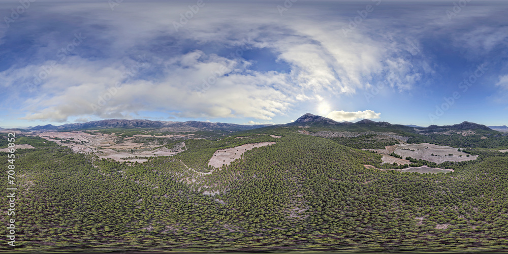 VR image 360 ​​view. Sunrise over pine forest and colorful sky with clouds and sun. Panoramic aerial view. Spain.
