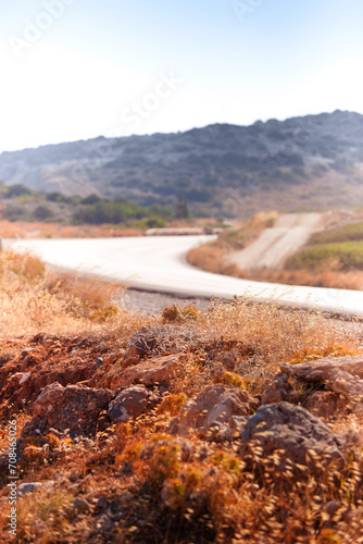 Rocks and dry grass near road