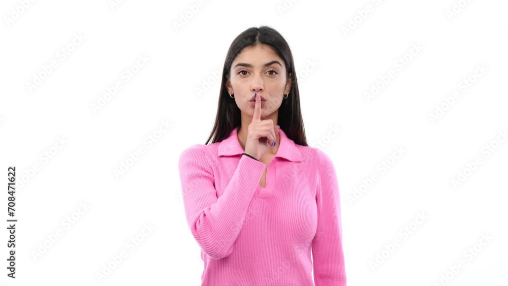 Serious Caucasian woman signals shh against a clean white background. This strong and resolute image conveys a sense of authority and hushed intensity. Serious Caucasian woman signals shh against a clean white background. This strong and resolute image conveys a sense of authority and hushed intensity.