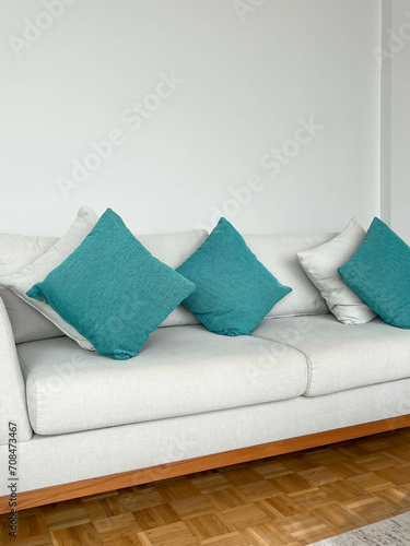 Fototapeta Naklejka Na Ścianę i Meble -  new sofa with small green pillows in a living room