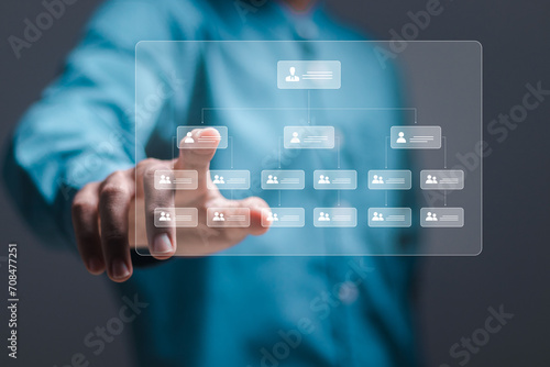  Business workflow process management concept. Businessman touch workflow automation system with data diagram of hierarchical structure of departments in business organization.