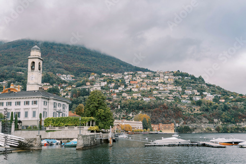 Motor boats are moored at the pier in the town of Cernobbio. Lake Como, Italy