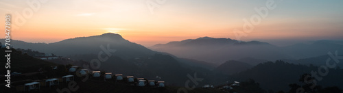 nature view of mountain forest landscape with sunrise and mist in the morning. Natural scenery outdoor travel background. 