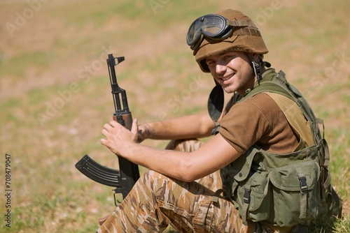 Military, warrior and smile with portrait of man in nature for war, conflict and patriotism. Army, surveillance and security with person training on battlefield for soldier, courage and veteran