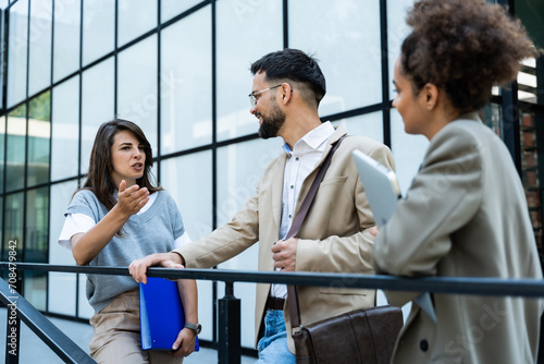 Group of young business people product strategy experts waiting for staff meeting with employer from human resources for job search in front of office building. Businessmen and businesswomen discuss