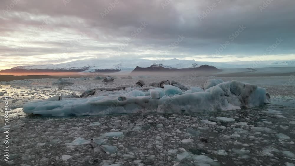 Spectacular drone aerial view of Iceland's largest glacier and a beautiful sunset over a huge glacial mass and reflecting on a glacial lake, Jokulsarlon and Vatnajökull gracier, Iceland Spectacular drone aerial view of Iceland's largest glacier and a beautiful sunset over a huge glacial mass and reflecting on a glacial lake, Jokulsarlon and Vatnajökull gracier, Iceland