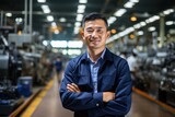 Portrait of a male Asian factory worker smiling