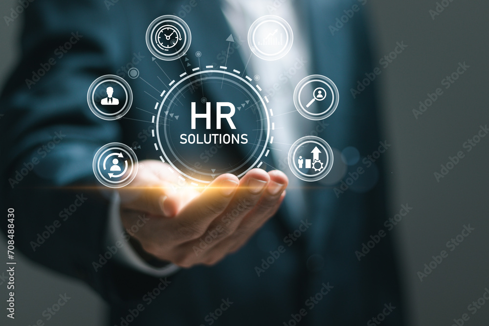 HR Solutions concept. Businessman holding human resources solutions icons for human resources management tool used to manage employee information in organization. HR Solutions concept. Businessman holding human resources solutions icons for human resources management tool used to manage employee information in organization.