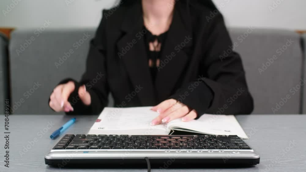Hands on a digital tablet keyboard close-up of a girl working in an office remotely typing text and counting money, woman using a notepad Distance learning online education and work