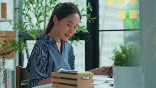 focused and dedicated work with asian female woman concentrating on her tasks in the office professionalism concentration and a productive work environment making it an ideal seeking success work photo