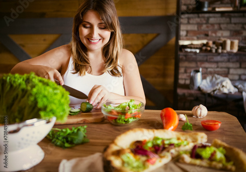 Young woman making vegetable salad