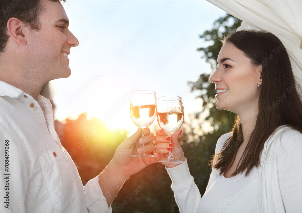 Young happy couple enjoying a glasses of white wine Young happy couple enjoying a glasses of white wine