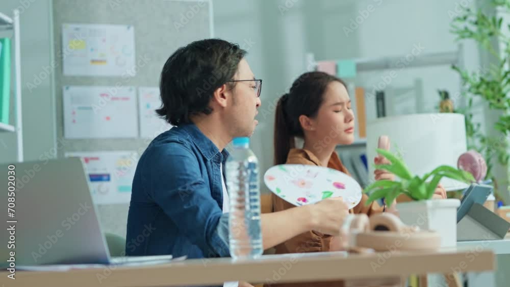 asian businessman and woman Sweating due to hot climate while air condition is not work Exhausted young man trying to cool off with hand fan suffering in summer heat in circle sweaty overheated work asian businessman and woman Sweating due to hot climate while air condition is not work Exhausted young man trying to cool off with hand fan suffering in summer heat in circle sweaty overheated work