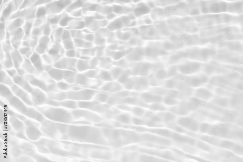 White water with ripples on the surface. Defocus blurred transparent white colored clear calm water surface texture with splashes and bubbles. Water waves with shining pattern texture background.