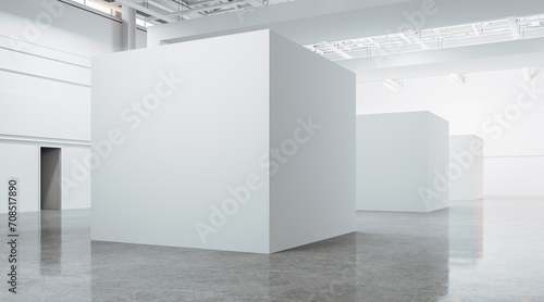 Open space large gallery interior with blank white boxes on concrete floor photo
