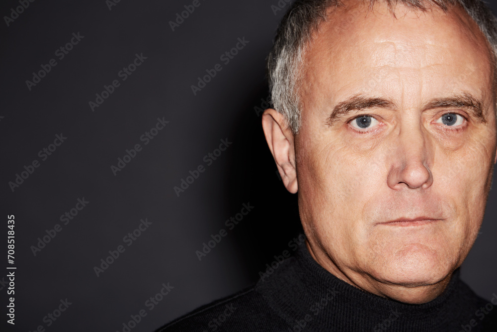 Fototapeta premium Portrait of mature man in studio with serious face, confidence and wise in dark space. Pride, relax and senior businessman ceo isolated on black background with expert knowledge, mockup and wisdom.