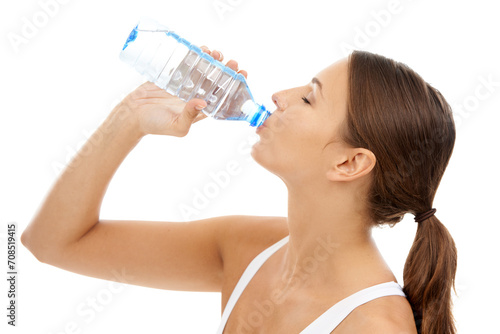 Fitness, woman and drinking water in studio for exercise break, energy and healthy detox on white background. Thirsty model, liquid hydration and bottle for sports nutrition, weight loss diet or care