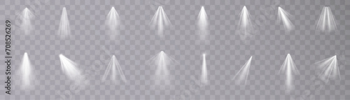 Set of isolated spotlight light effects. White glowing spotlight on a transparent background.