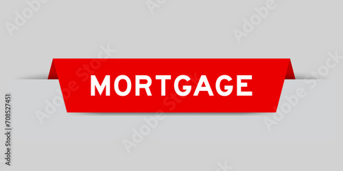 Red color inserted label with word mortgage on gray background
