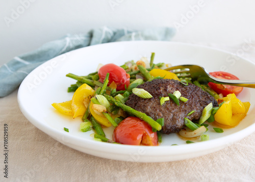 plate with steak with asparagus garnish on the table