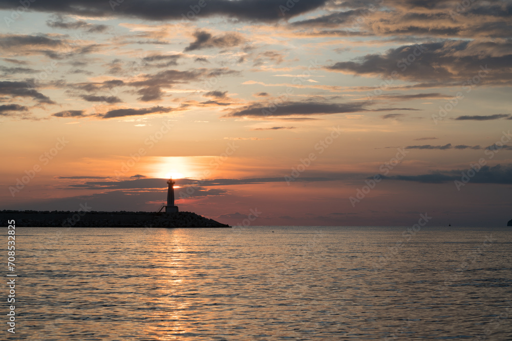 lighthouse at sunset and magnificent sky with textured clouds lighthouse at sunset and magnificent sky with textured clouds