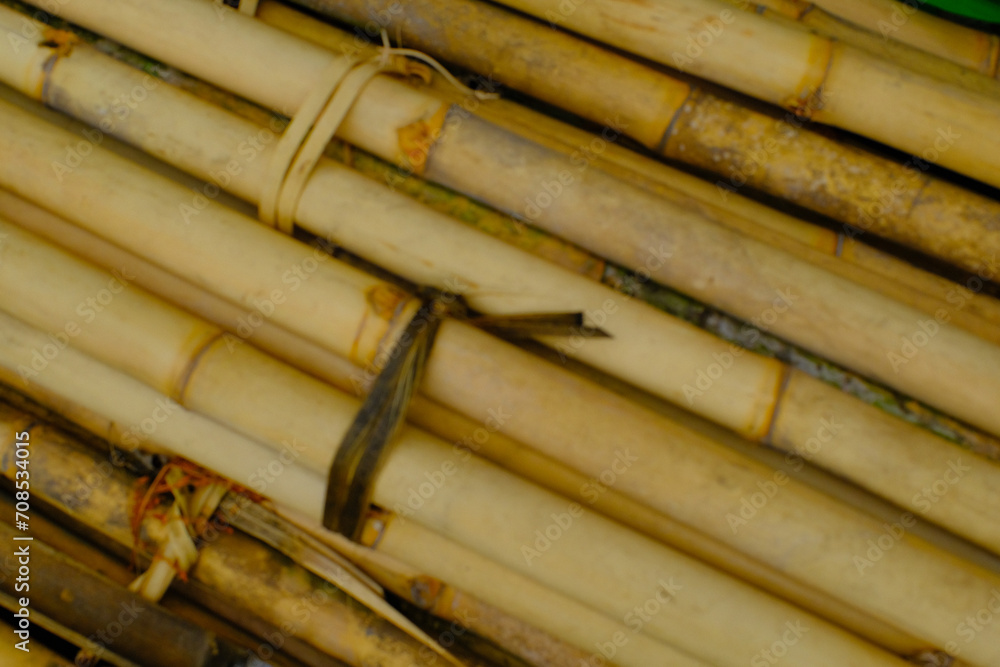 Background Photography. Textured Background. A pile of bunches of old yellow bamboo. Old bamboo is collected on the side of the road for building construction. Bandung, Indonesia Background Photography. Textured Background. A pile of bunches of old yellow bamboo. Old bamboo is collected on the side of the road for building construction. Bandung, Indonesia