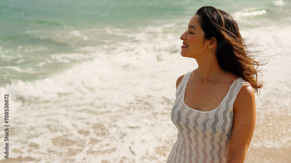 Beautiful girl with straw hat walking and enjoying sunbath at beach. Young tanned woman with closed eyes enjoying breeze at seaside. Carefree latin woman smiling with ocean in background.
Beautiful girl with straw hat walking and enjoying sunbath at beach. Young tanned woman with closed eyes enjoying breeze at seaside. Carefree latin woman smiling with ocean in background.