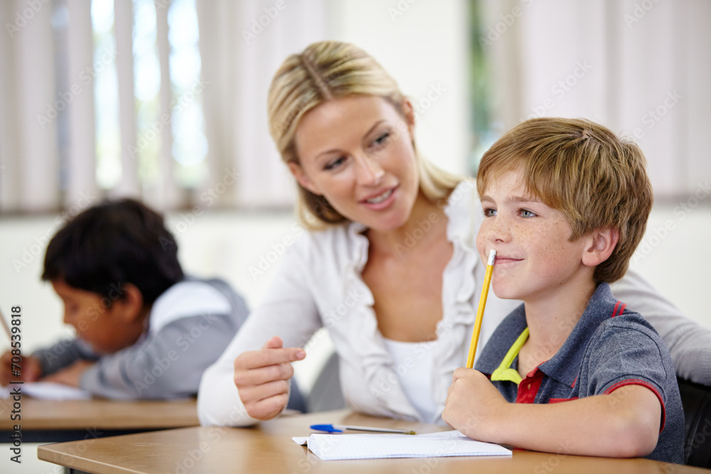 Teacher, student and help, study and education in class, question and think of answer for school work and knowledge. Teaching, learning and woman with boy in classroom and problem solving for test Teacher, student and help, study and education in class, question and think of answer for school work and knowledge. Teaching, learning and woman with boy in classroom and problem solving for test