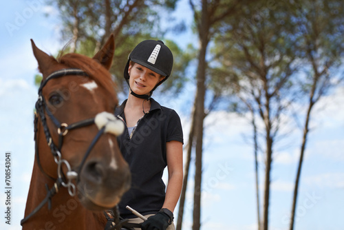 Equestrian, portrait and riding a horse in nature on adventure, journey and happiness in countryside. Ranch, animal and rider outdoor with hobby, sport and pet on farm with girl on blue sky in summer