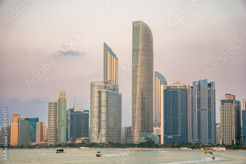 Abu Dhabi skyline at sunset, from the Abu Dhabi view point, in the UAE, hazy dusk colored sky, in pink. © John