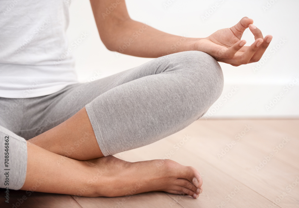 Fototapeta premium Person hands, meditation and spiritual in a home with mockup space and chakra for balance and mindfulness. Morning, wellness care and zen in house on floor to relax for calm and peace in lotus pose