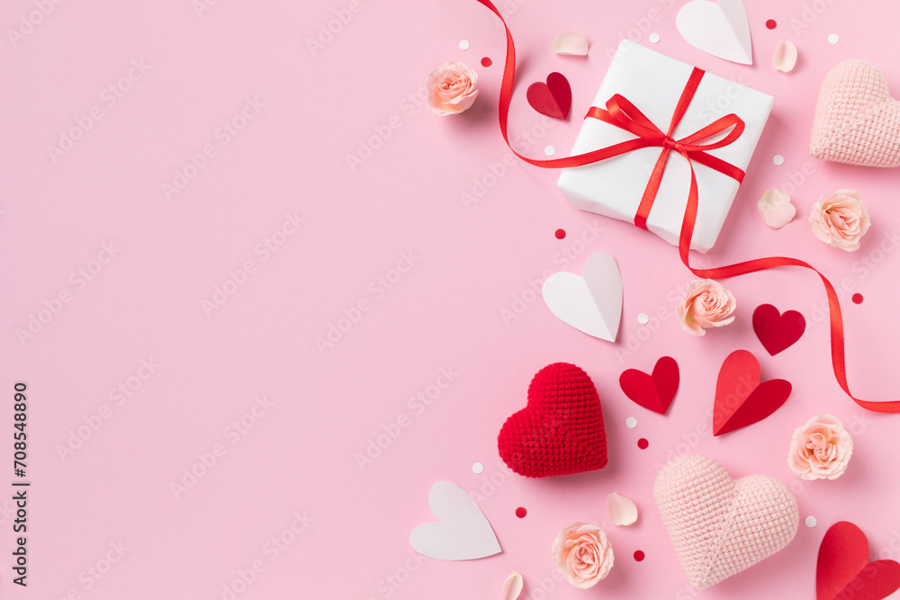 Valentine or mother day festive composition with gift or present box, rose flowers and red pink hearts on pastel background top view. Beautiful greeting card..