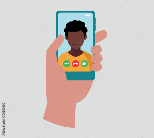 Eine Hand hält ein Smartphone mit einer Videokonferenz auf dem Bildschirm.