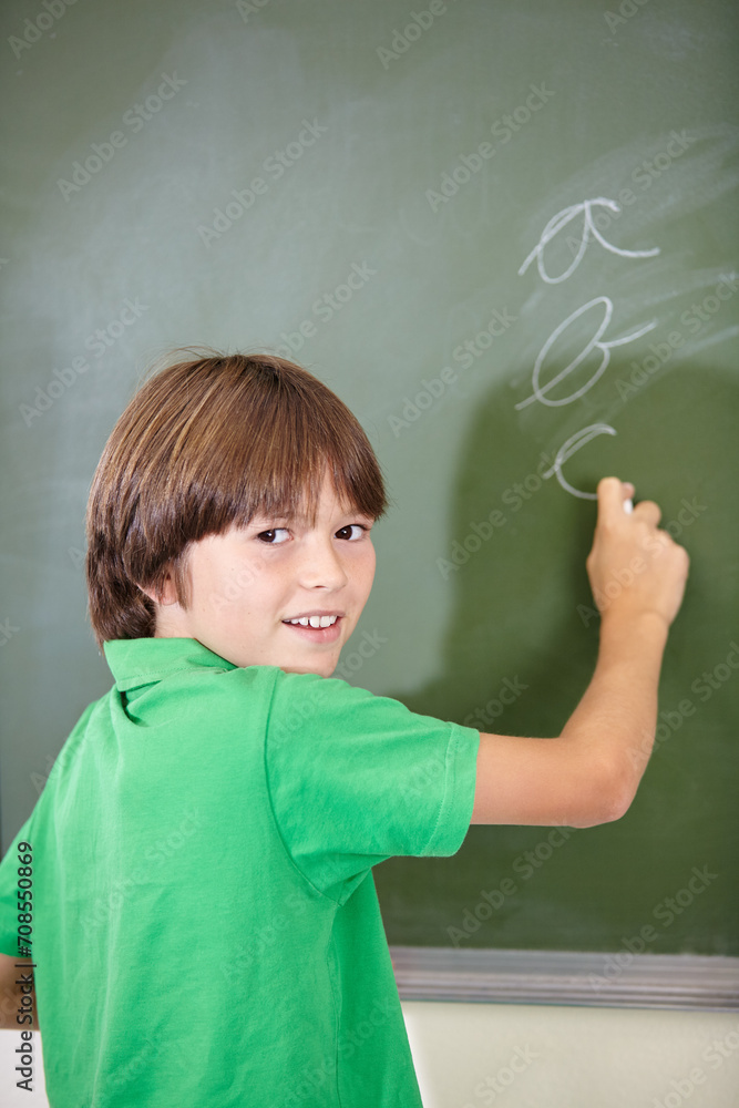 Portrait, knowledge and boy drawing on a chalkboard for child development, creativity and art for learning. Academic, face and kid student writing with information in the classroom and answers