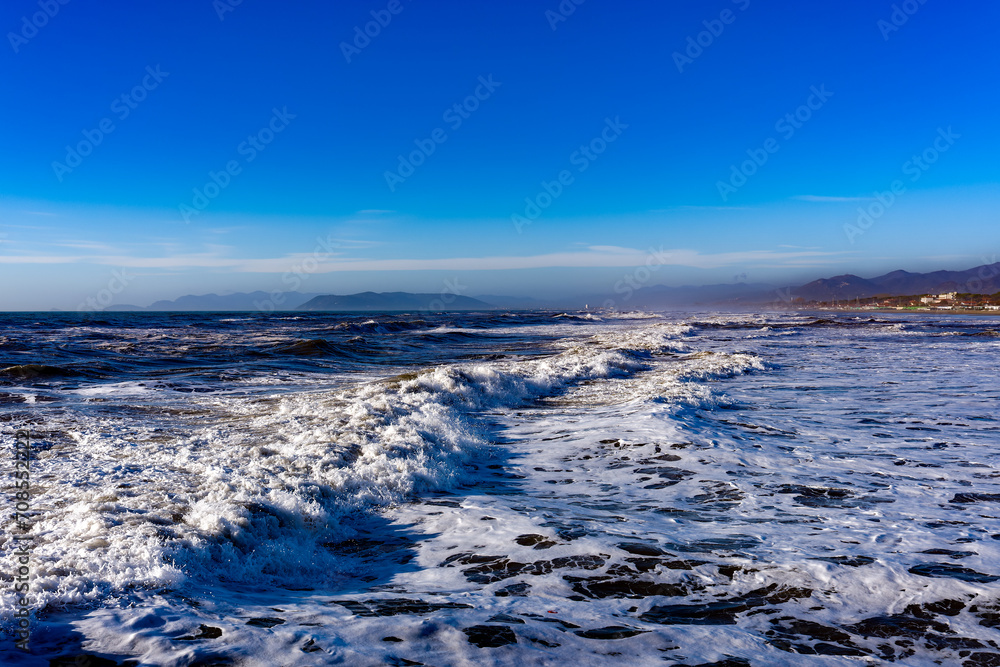 Seascape on a day with very rough seas in the background the beach and the town of Forte dei Marmi Tuscany Italy
