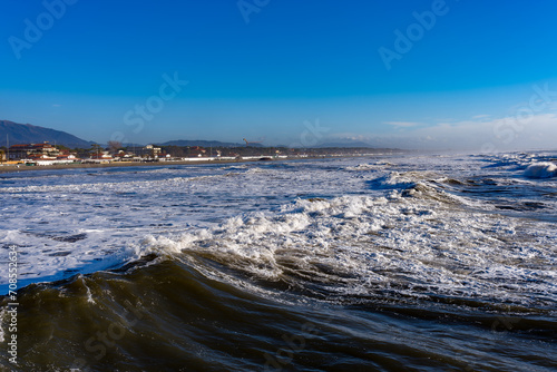 Seascape on a day with very rough seas in the background the beach and the town of Forte dei Marmi Tuscany Italy