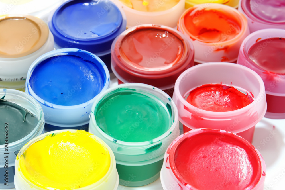 children's hobby. bright colored gouache paints in small transparent jars close-up top view, artistic concept children's hobby. bright colored gouache paints in small transparent jars close-up top view, artistic concept