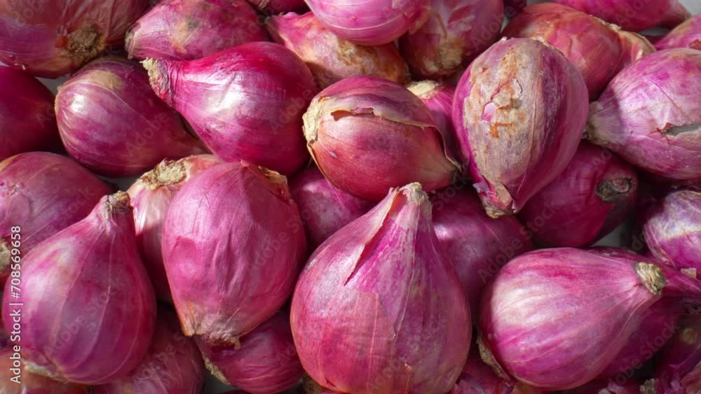 A close-up view captures the intricate textures of red shallots, showcasing their graceful curves and captivating shades, a miniature masterpiece. 4K.
A close-up view captures the intricate textures of red shallots, showcasing their graceful curves and captivating shades, a miniature masterpiece. 4K.