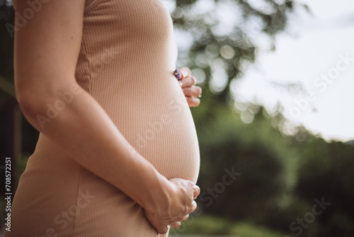 pregnant woman holding her belly